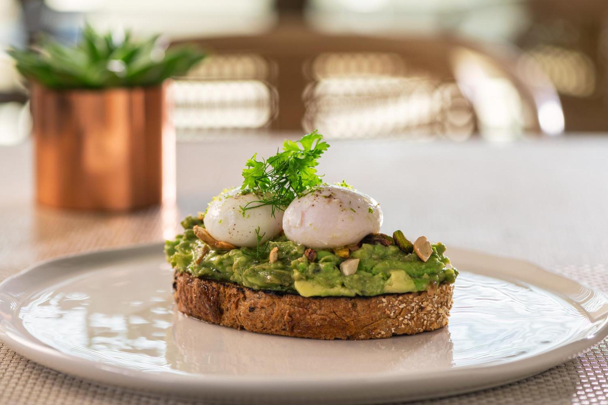 The Abu Dhabi Edition Exterior photo Avocado on toast with poached eggs